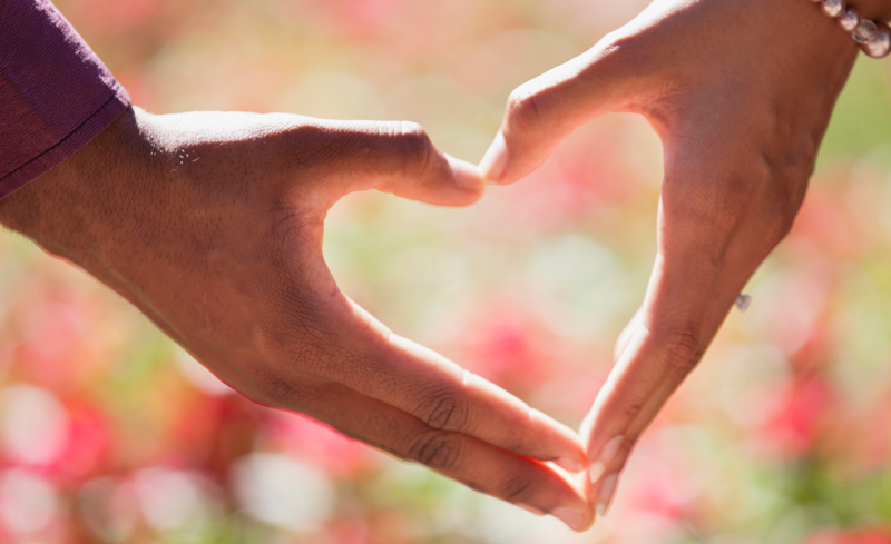 two individual hands forming a heart shape showing relationships.